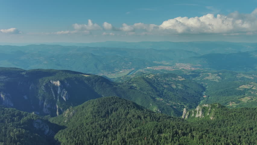 Aerial view on mountains, hills and meadow, village in Tara national park, Serbia, 4k