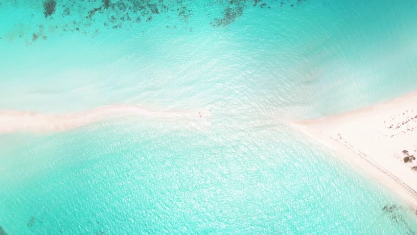 Top down aerial view of sandbar of Cayo de Agua, Los Roques, Venezuela, turquoise beach merging with shallow sea.