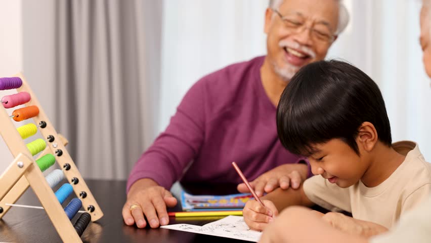 Elderly man and young boy color together at a cozy home table with abacus.