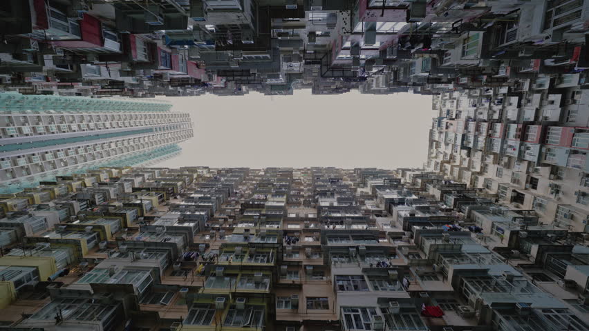 Famous Monster building with small balconies on facade in dwelling block under gloomy sky. Old condominium complex popular among tourists in Asian city. Architecture