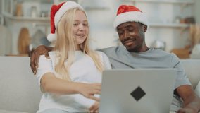Portrait of happy interracial spouses in Christmas, video call by laptop. Celebration of merry winter fest, blonde norwegian lady and african american guy embracing and chatting cheerful, happiness - Powered by Shutterstock - Get 15% off with code: PIKWIZARD15