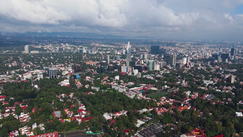 Drone film of Mexico City during an overcast, rainy day across metropolis