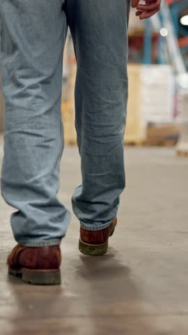 Feet, person and walking for logistics at warehouse for inspection, quality control and supply chain. Shoes, back or storage for stock check, inventory management or supervisor for cargo distribution