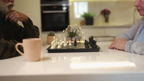 Happy senior couple playing chess together at home, enjoying leisure hobby - Powered by Shutterstock - Get 15% off with code: PIKWIZARD15