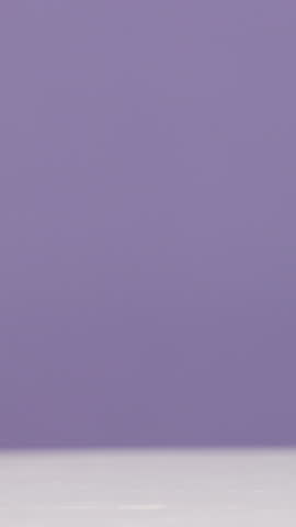 Empty, tube and lip gloss in studio for makeup, cosmetics or product review on purple background. Space, mockup and selection of lipstick color for shine, hydration or moisturizer for beauty campaign