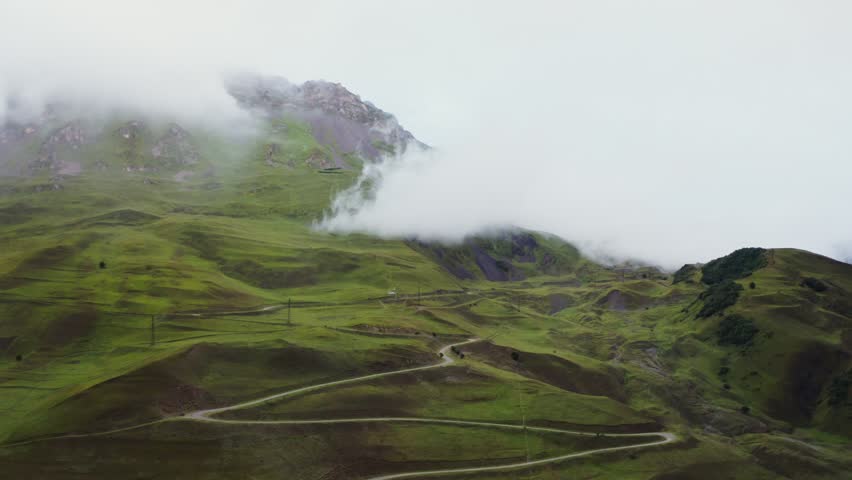 Exploring a scenic mountain valley in Russia’s Caucasus region, featuring lush alpine landscapes, rugged peaks, and breathtaking natural beauty for adventure and travel enthusiasts.