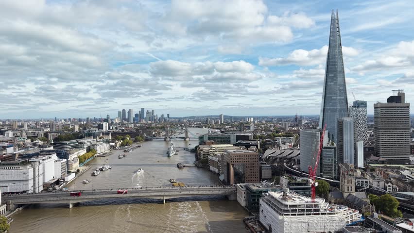 The Shard on banks of River Thames London pull back drone aerial reverse reveal
