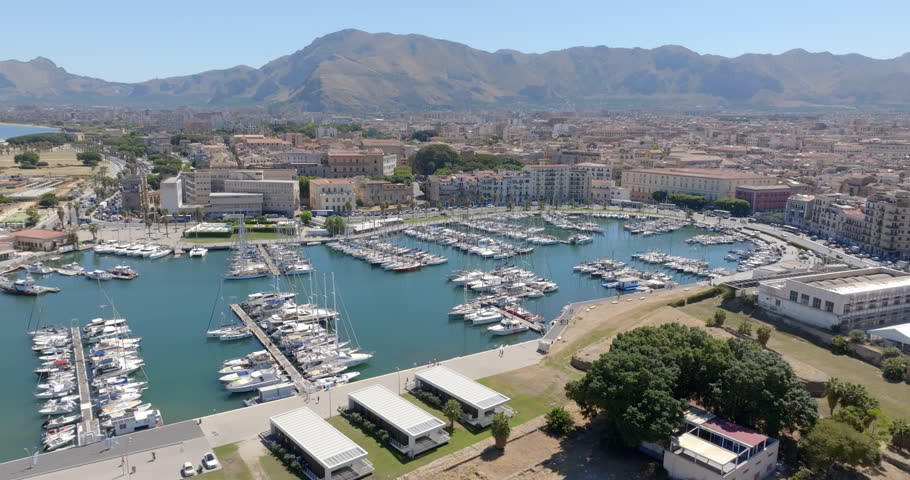 Aerial view of the small tourist port called "La Cala" and located in Palermo, Sicily, Italy. There are many boats in the marina overlooking the Mediterranean Sea.
