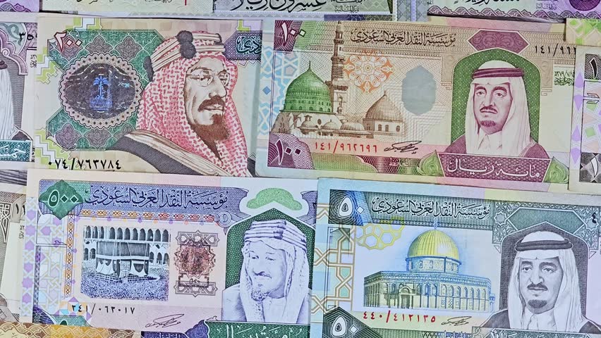 Saudi Arabian riyals SAR banknotes cash money bills, of different times, eras and values, from old vintage retro King Fahd times till king Salman time, Saudi Arabia riyals money and economy concept