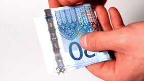 Man's hands counting the bundle of 20 euro banknotes. Money counting. Hands counting a stack of twenty Euro banknotes. video of a person counting 20 euro bills. Expenses and income. - Powered by Shutterstock - Get 15% off with code: PIKWIZARD15