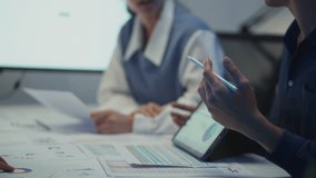 Diverse team of employees planning for startup success, using digital tablets and documents in a modern office. - Powered by Shutterstock - Get 15% off with code: PIKWIZARD15