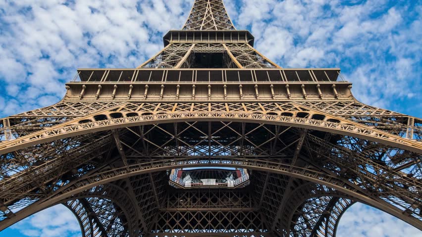 Close up on the iron structure of the Eiffel Tower in Paris, France, on a beautiful Spring day with blue sky. A close view of the Eiffel Tower