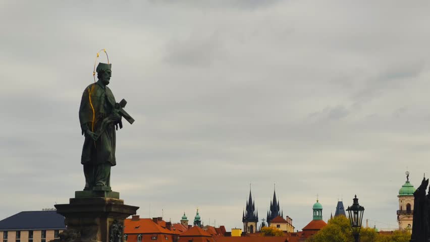 Charles Bridge Prague slow motion cinematic 4K B-ROLL footage showcasing Gothic tower, Baroque statues, autumn colors, and historic architecture in stunning cityscape. Iconic European landmark reveals timeless cultural heritage with ornate sculptures and medieval stonework captured in beautiful seasonal atmosphere. Famous Czech bridge displays architectural masterpiece and romantic urban setting creating enchanting travel destination moment. Premium cinematic quality delivers inspiring visual content perfect for advertising, marketing campaigns, branding projects, social media content, travel documentaries, tourism websites, corporate presentations, and creative editorial projects requiring elegant European city imagery.
