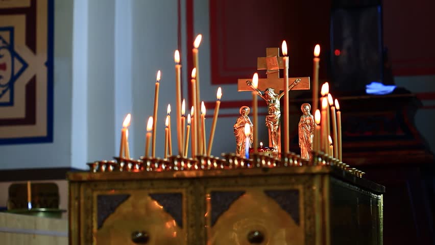 A group of candles lit in a peaceful church setting, great for backgrounds or inspirational images.