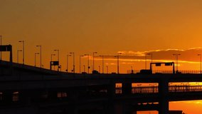 Golden sunset over a highway bridge with silhouette of traffic and streetlights - Powered by Shutterstock - Get 15% off with code: PIKWIZARD15
