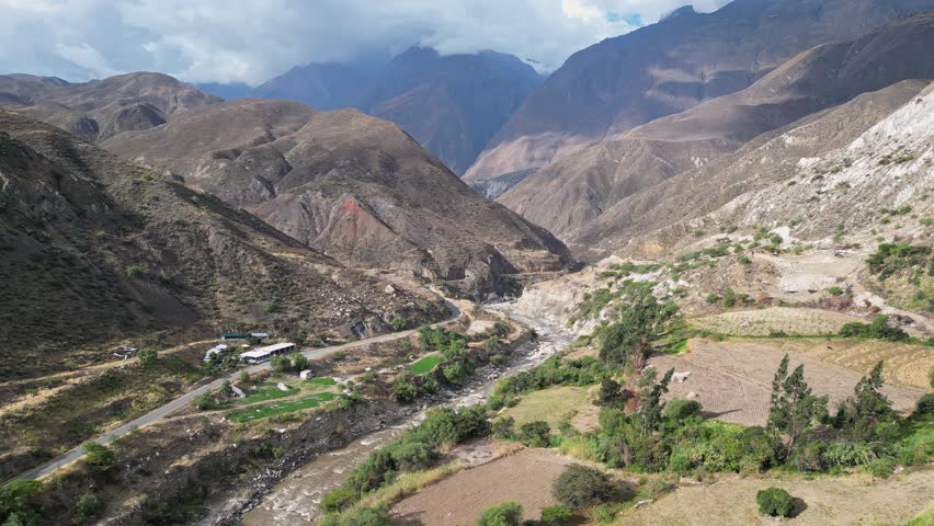 Huaraz, Peru: Forward aerial drone footage above the river Rio Santa flowing in valley of canon del pato in Huaraz region, Peru with dramatic mountains in the background
