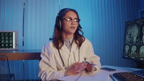 Female Doctor With Headset Analyzes MRI Brain Scans on Computer Using AI-Based Tools, Recording Data for Advanced Diagnostics. Concept of Digital Healthcare, Innovation, and Smart Medical Technology. - Powered by Shutterstock - Get 15% off with code: PIKWIZARD15