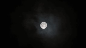Vertical video - Thin layers of cloud slightly covering the full moon - Powered by Shutterstock - Get 15% off with code: PIKWIZARD15