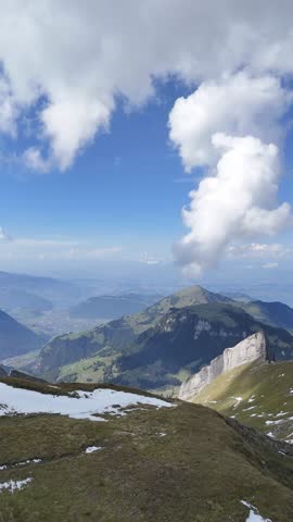 Drone fly-over footage of Swiss Alps with dramatic cloud formations