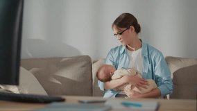 Remote Work, Modern Parenting, Hybrid Lifestyle. A Professional Woman Works From Home While Holding Her Baby, Surrounded by Office Tools. A Scene of Flexibility, Family Inclusion, and Digital - Powered by Shutterstock - Get 15% off with code: PIKWIZARD15