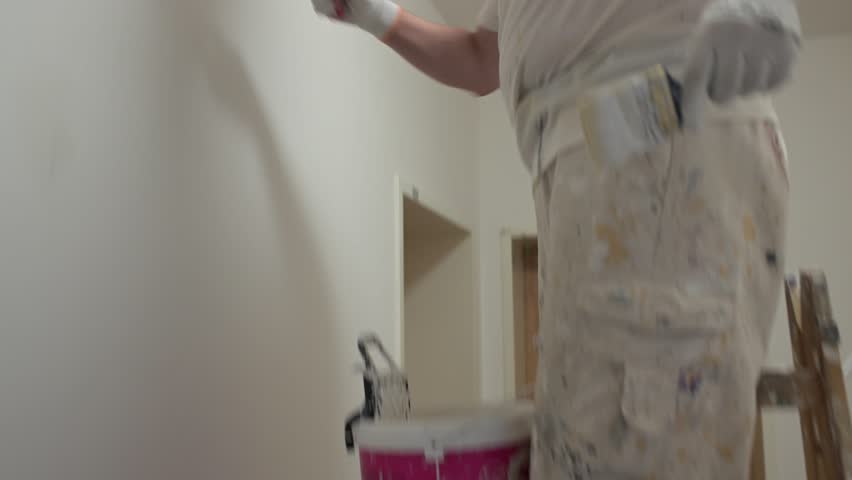 Man painting ceiling with roller — home interior renovation, horizontal 4K