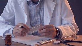 A doctor writes a prescription Male medicine medical practitioner hand hold document patient journal medical and medication at hospital. movie slow - Powered by Shutterstock - Get 15% off with code: PIKWIZARD15