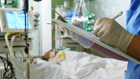 A doctor writes a prescription of critical sick Male patient medicine. medical practitioner hand hold document patient journal medical and medication at hospital. movie slow - Powered by Shutterstock - Get 15% off with code: PIKWIZARD15