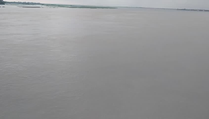 Turbulent Saryu river flow near bridge.
