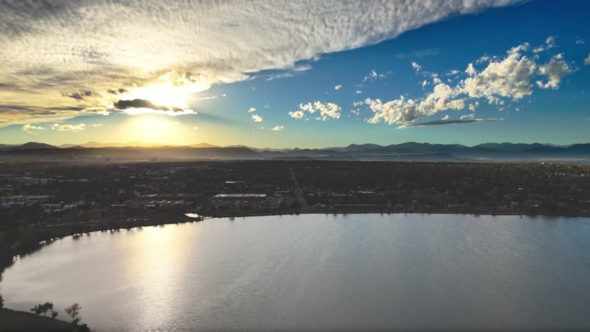 Drone Video of Sloan’s Lake Park and Rocky Mountains at Sunset in Denver, Colorado. Captured in cinematic 4K, the aerial footage showcases one of Denver’s most scenic urban retreats.