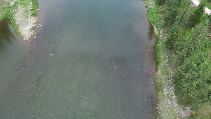 Railroad bridge over Clark Fork River in Montana. Unusual design is due to additional reinforcing structure to carry heavier trains. High angle flyover shot of the bridge.