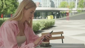 Blonde Woman Texting On Smartphone At Outdoor Cafe Table With Coffee - Powered by Shutterstock - Get 15% off with code: PIKWIZARD15