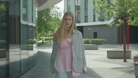 Blonde Woman Arguing Passionately While Facing Camera In Urban Environment - Powered by Shutterstock - Get 15% off with code: PIKWIZARD15