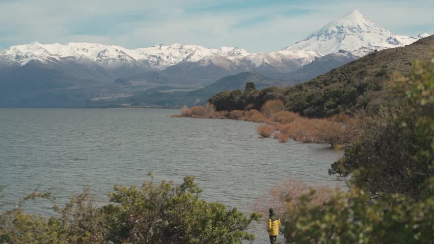 View of a Vast Lake Huechulafquen Shore with a Backdrop of Dramatic Snow-Capped Mountains. Neuquen, Argentina
