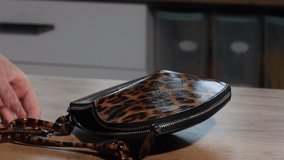 A woman is reviewing a leopard print bag. - Powered by Shutterstock - Get 15% off with code: PIKWIZARD15