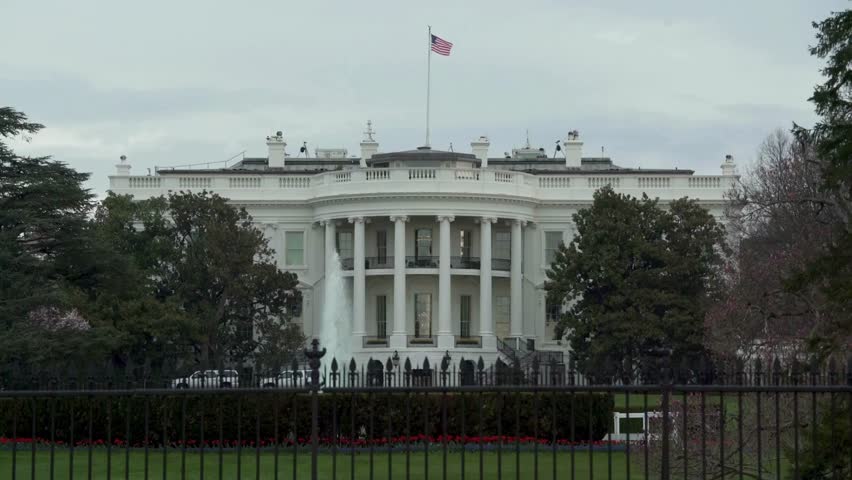 Static shot of the White House in Washington DC from across the street Dramatic storm clouds over the northern facade of The White House in