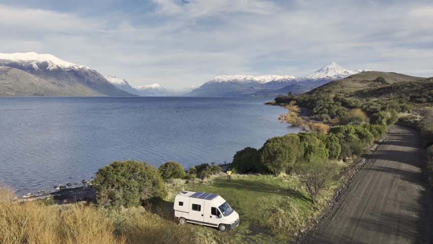 Motorhome Van Parked by a Lake with Majestic Snow-Capped Mountains by Lake Huechulafquen. Lanin National Park, Neuquen, Argentina