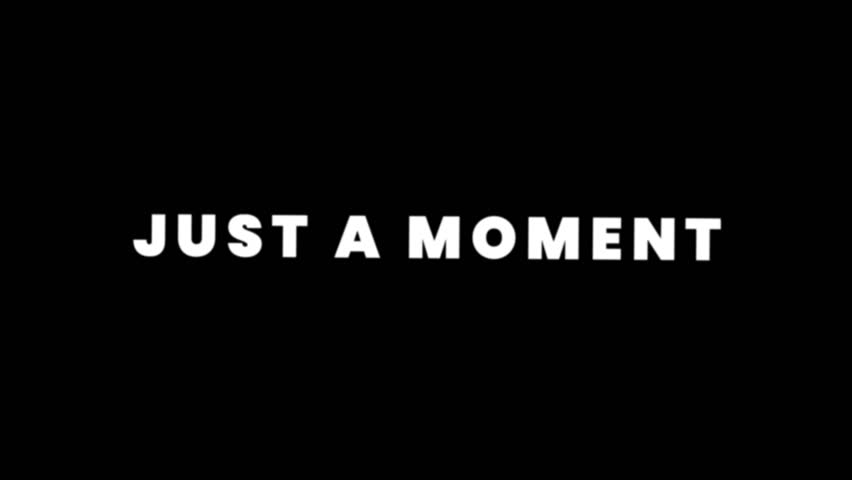 Loop animation showing bold white text “Just a Moment” on a black background, symbolizing waiting, pause, patience, or short delay messages.
