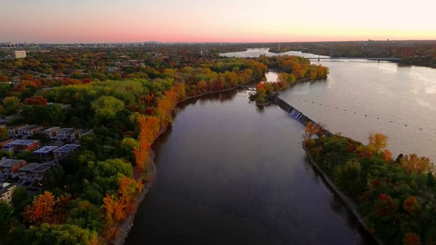 Drone Aerial View of Rivière des Prairies at Sunset in Montreal, Quebec, Canada Showing Golden Light Over the River, Urban Landscape, and Natural Scenery in a Peaceful Evening Atmosphere