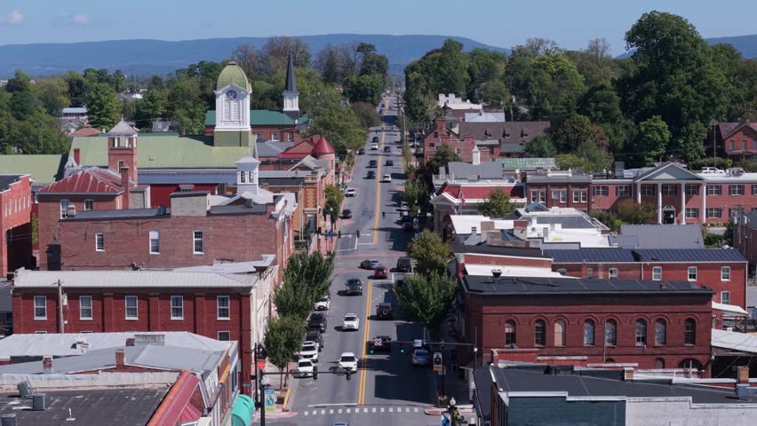 Enjoy a stunning aerial view of Main Street in Charles Town, West Virginia, showcasing its historic courthouse and vibrant community on a clear autumn day.
