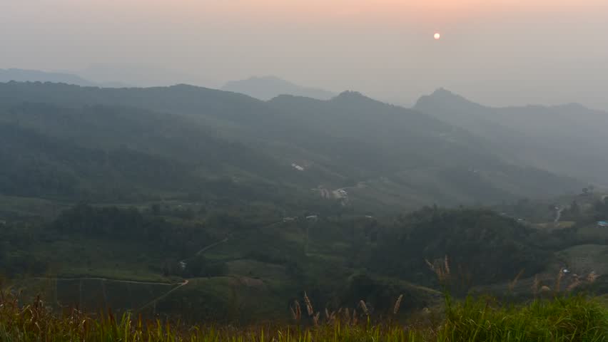 From above of white puffy clouds Flying through the clouds above mountain tops.