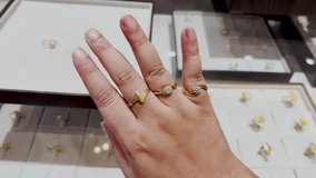 hand modeling fashionable gold ring stack combination with minimalist and floral designs - Powered by Shutterstock - Get 15% off with code: PIKWIZARD15