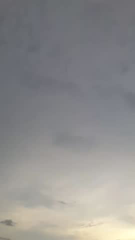 Gold ray of sundown slowly fall beyond the horizon, hot, grey cloudy, drizzle day, wet.