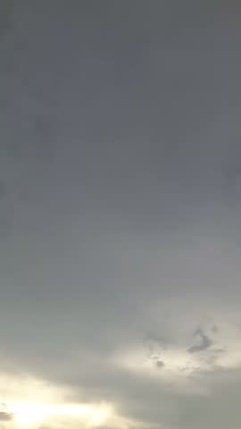 Gold ray of sundown slowly fall beyond the horizon, hot, grey cloudy, drizzle day, wet.