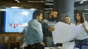 Mid adult man unfolding blueprint, activating floating business charts and guiding team review. Collaboration, teamwork, data visualization, brainstorming, modernoffice, infographic, presentation - Powered by Shutterstock - Get 15% off with code: PIKWIZARD15