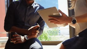 Colleagues tapping tablet initiating holographic UI with streaming code, pulsing charts and 6G logo. Technology, innovation, communication, digital, futuristic, collaboration, networking - Powered by Shutterstock - Get 15% off with code: PIKWIZARD15