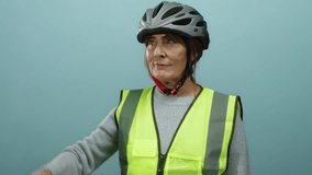 Senior hispanic woman with helmet and safety vest saluting while looking far with a hand on forehead against a blue isolated wall background. - Powered by Shutterstock - Get 15% off with code: PIKWIZARD15
