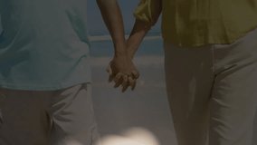 Senior man and woman walking along shore, bokeh initiating crucifix merging with bible for faith. Spirituality, devotion, serenity, faith, harmony, contemplation, reverence - Powered by Shutterstock - Get 15% off with code: PIKWIZARD15