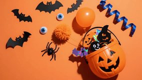 A halloween candy bucket jack o lantern black bat plastic spider orange balloon blue ribbon googly eye paper confetti party decor autumn holiday spooky fun celebration trick or treat pumpkin pail - Powered by Shutterstock - Get 15% off with code: PIKWIZARD15