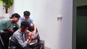 Young student collaborating discussing project documents on modern stairs - Powered by Shutterstock - Get 15% off with code: PIKWIZARD15