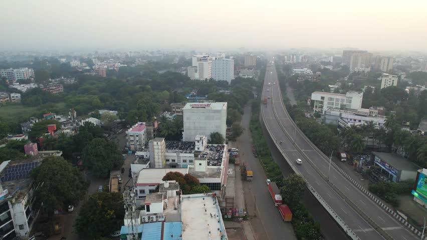 Mumbai Agra National highway crossing through Tier 2 Nashik city elevated corridor flyover, Nashik city covered in dense smog, air pollution, Maharashtra, Drone